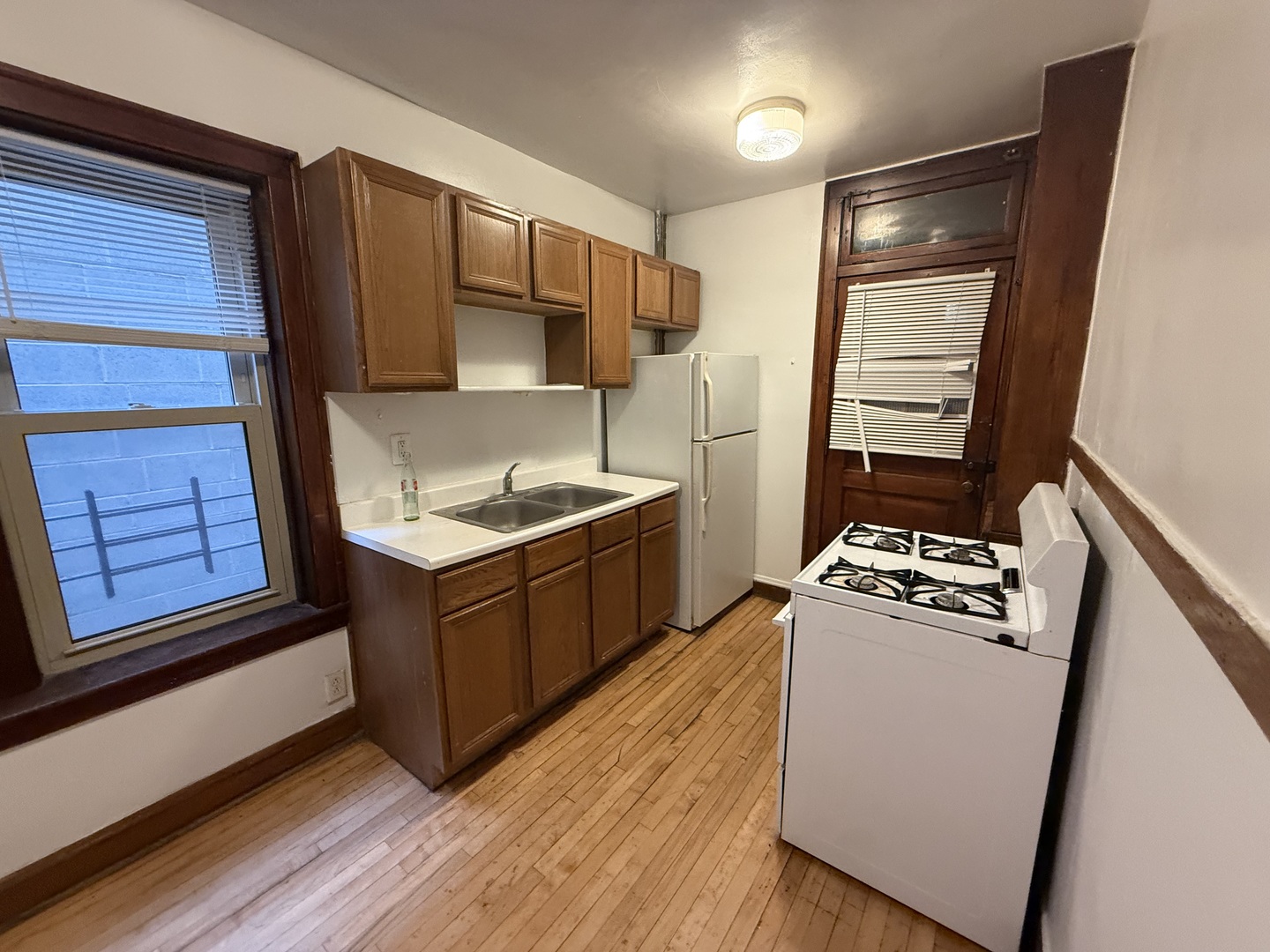 3152 North Linder Avenue, Unit 1 Chicago, IL 60641 - Photo 6 of 12 a kitchen with stainless steel appliances granite countertop a refrigerator stove and sink