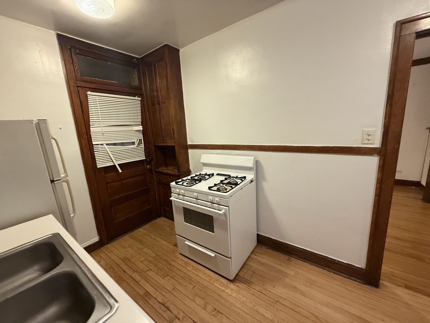3152 North Linder Avenue, Unit 1 Chicago, IL 60641 - Photo 7 of 12 a kitchen with a stove and a refrigerator