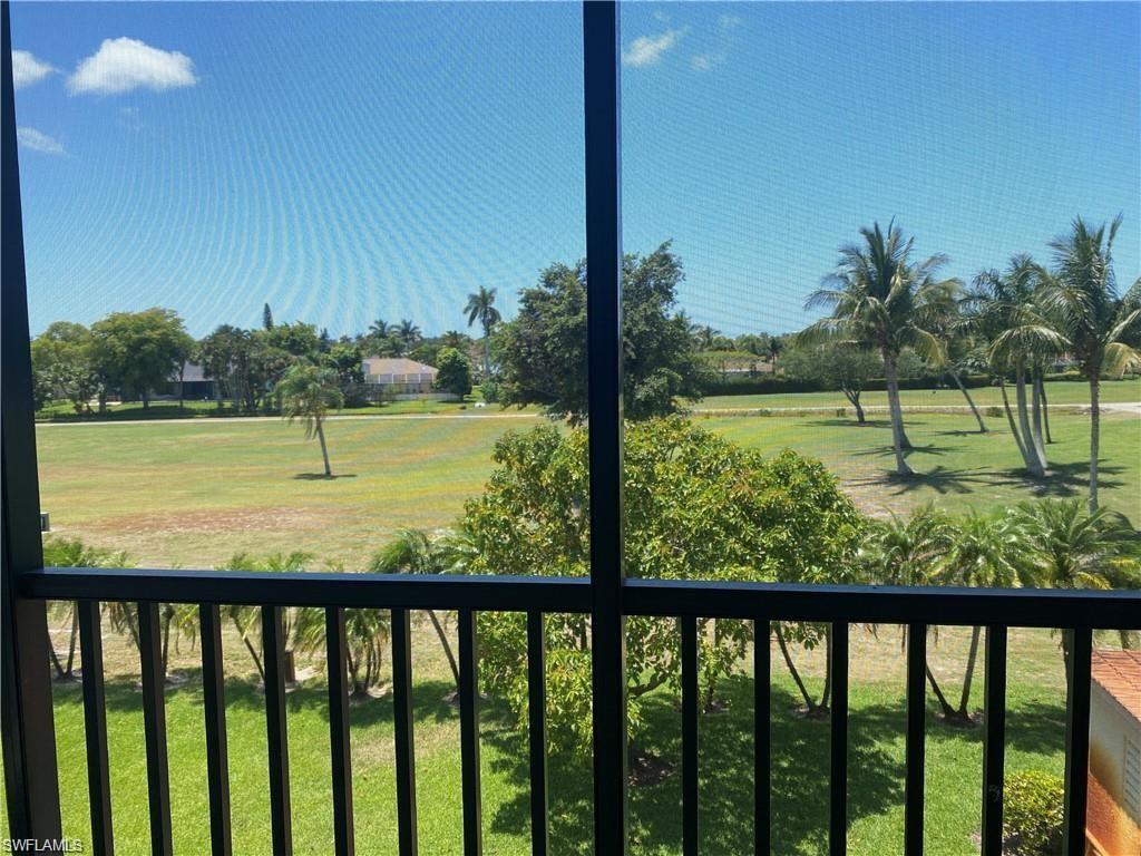 190 Pebble Beach Boulevard, Unit 301 Naples, FL 34113 - Photo 1 of 8 a view of outdoor space with green field and trees