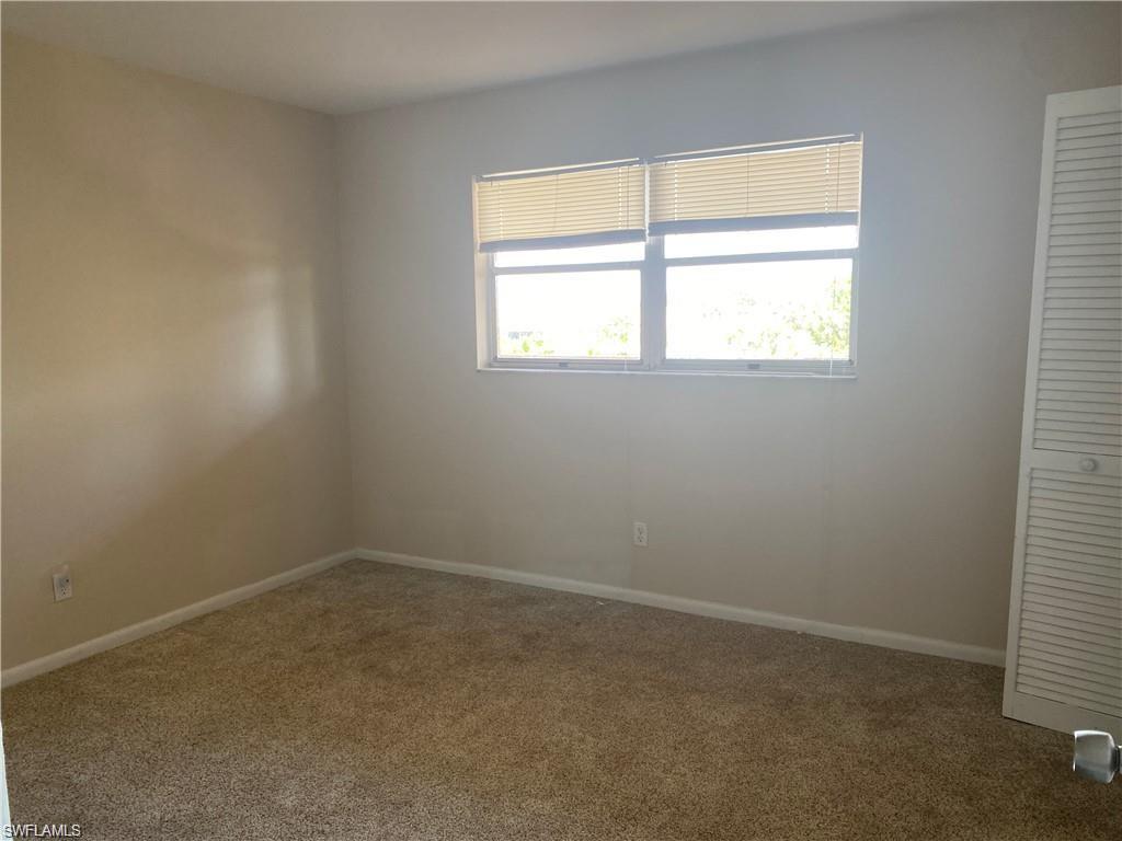 190 Pebble Beach Boulevard, Unit 301 Naples, FL 34113 - Photo 4 of 8 an empty room with a window