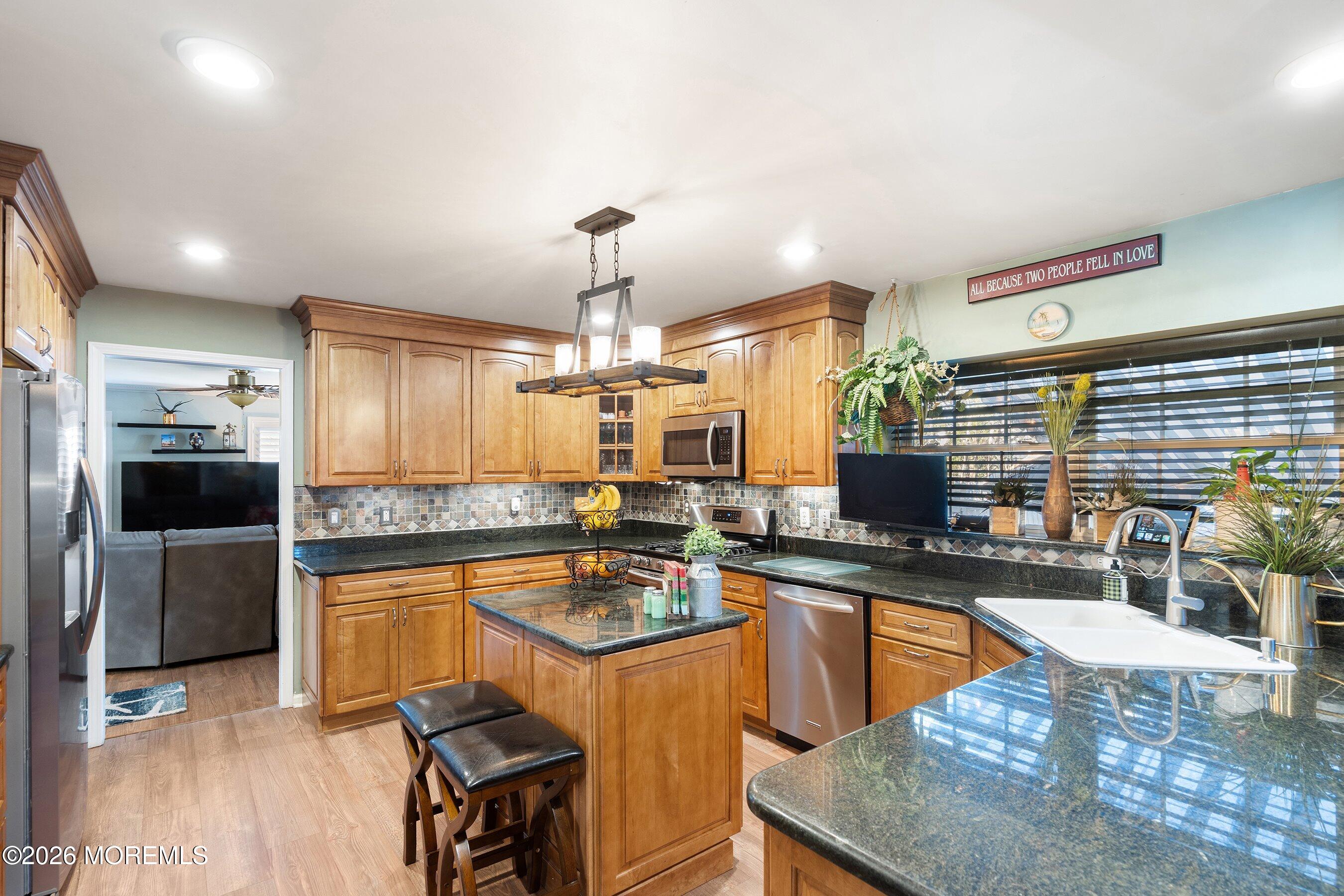 648 Point Avenue Brick, NJ 08724 - Photo 13 of 40 a kitchen with stainless steel appliances granite countertop a sink stove and refrigerator