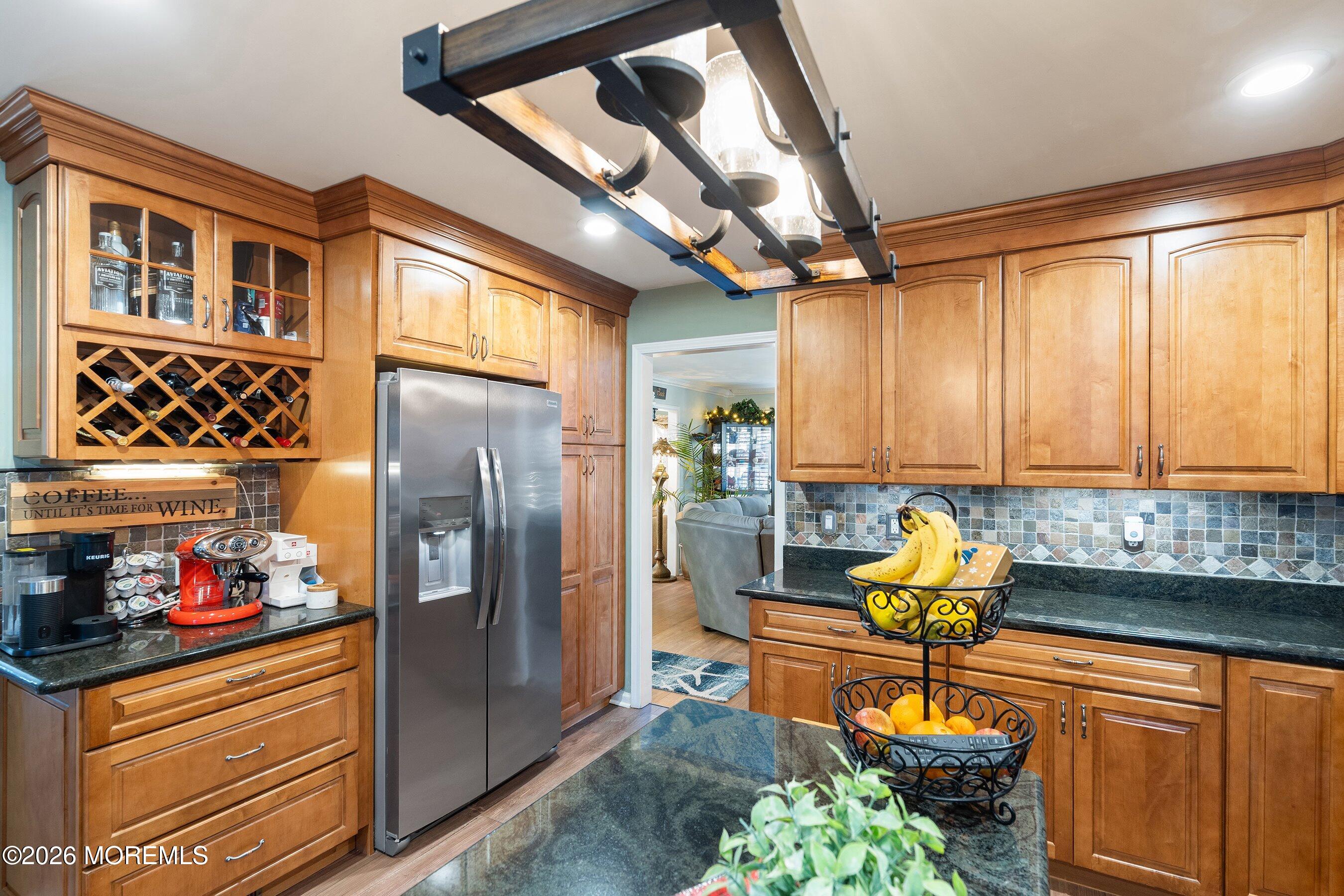 648 Point Avenue Brick, NJ 08724 - Photo 14 of 40 a kitchen with stainless steel appliances granite countertop a refrigerator and a sink