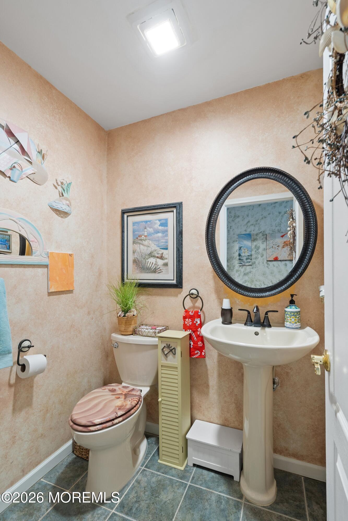 648 Point Avenue Brick, NJ 08724 - Photo 17 of 40 a bathroom with a toilet a sink and a mirror