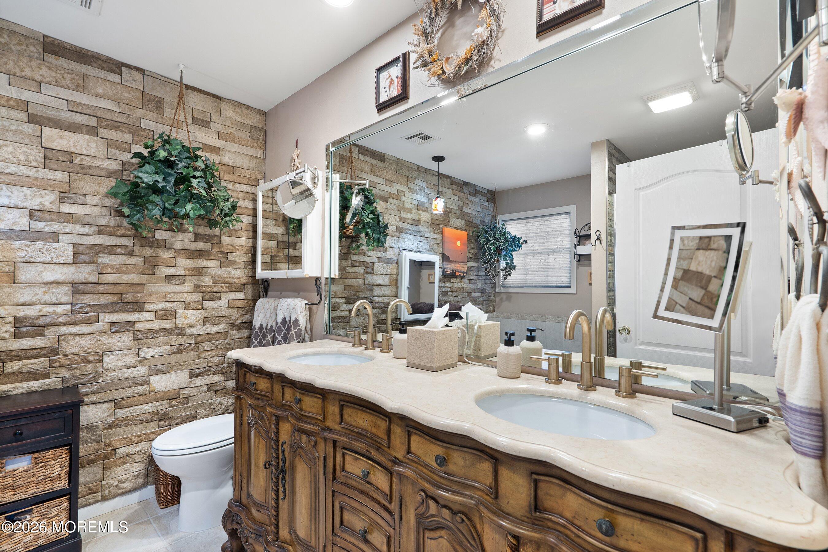 648 Point Avenue Brick, NJ 08724 - Photo 22 of 40 a bathroom with a double vanity sink toilet and a mirror