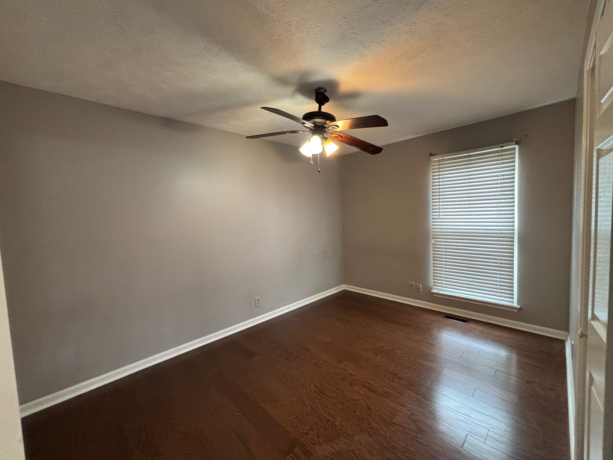 917 Tavistock Place Antioch, TN 37013 - Photo 7 of 14 an empty room with wooden floor and windows