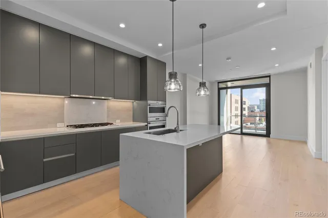 a kitchen with kitchen island a sink stainless steel appliances and cabinets