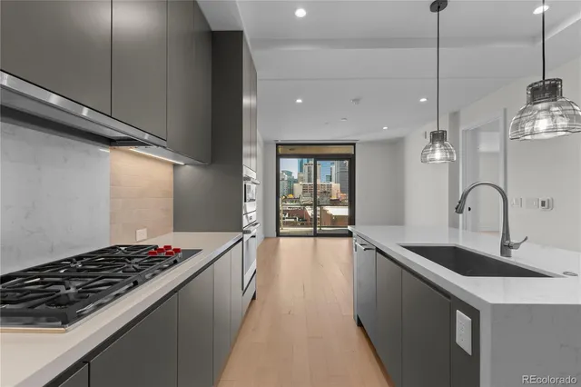 a kitchen with sink stove and cabinets