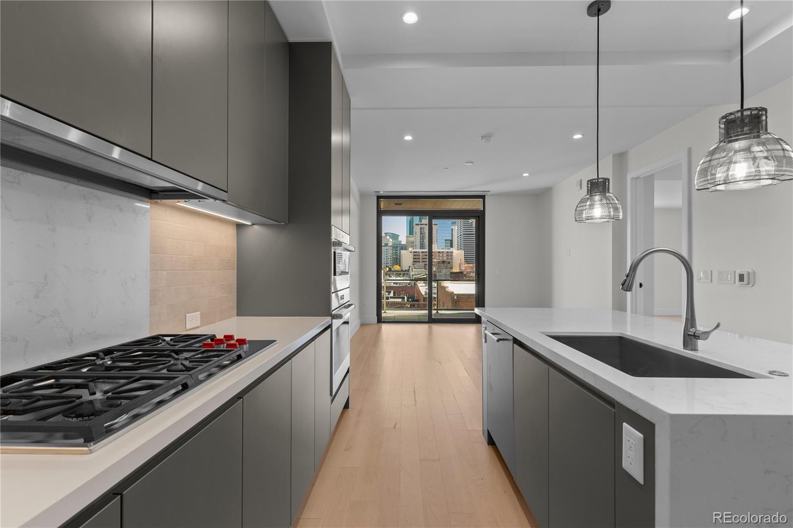 1901 Wazee Street, Unit 507 Denver, CO 80202 - Photo 11 of 45 a kitchen with sink stove and cabinets
