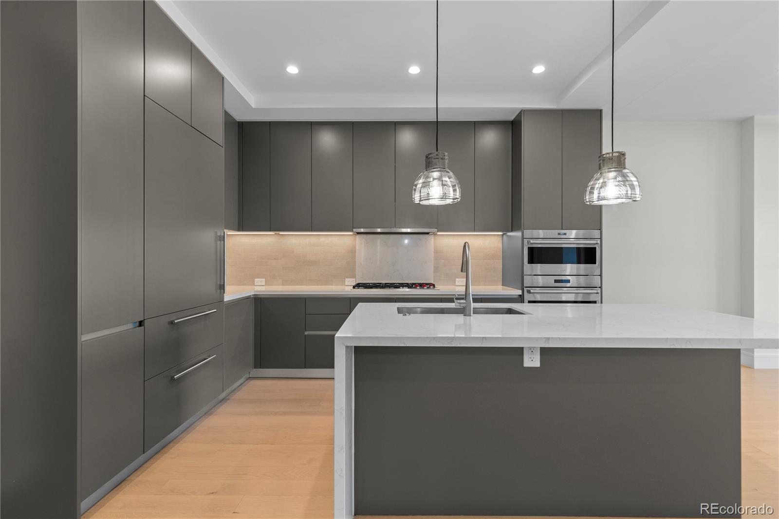 1901 Wazee Street, Unit 507 Denver, CO 80202 - Photo 12 of 45 a kitchen with kitchen island a sink stainless steel appliances and counter top space