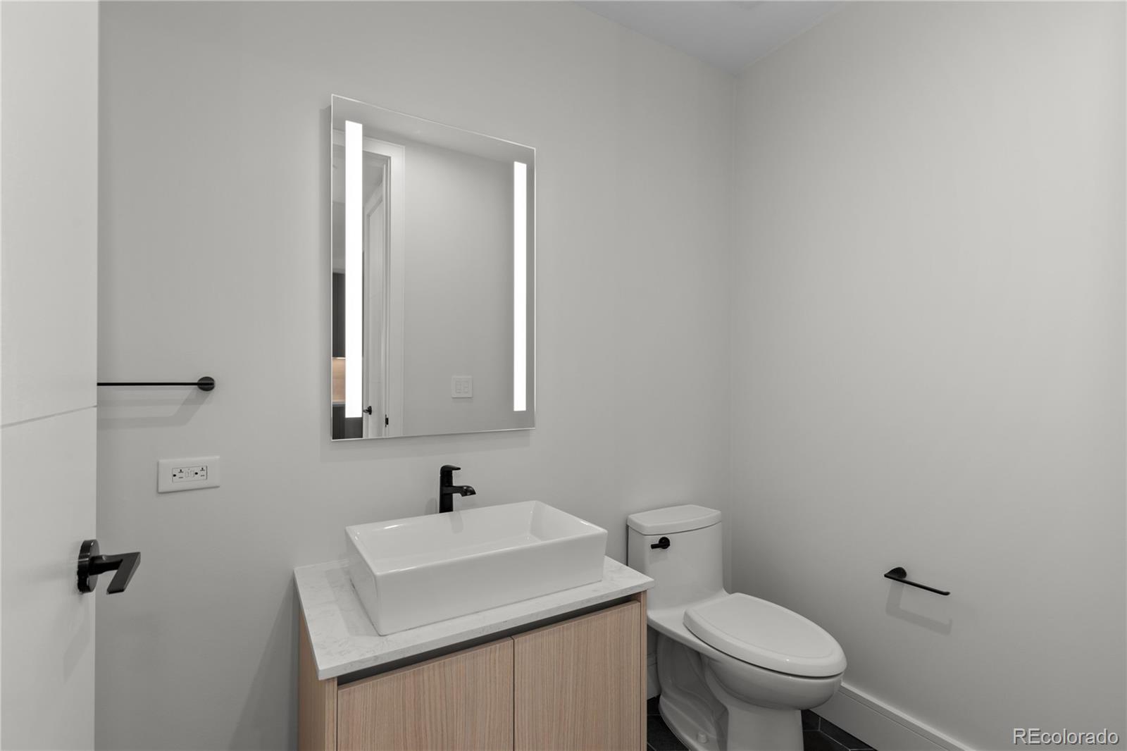 1901 Wazee Street, Unit 507 Denver, CO 80202 - Photo 14 of 45 a bathroom with a sink a toilet and mirror