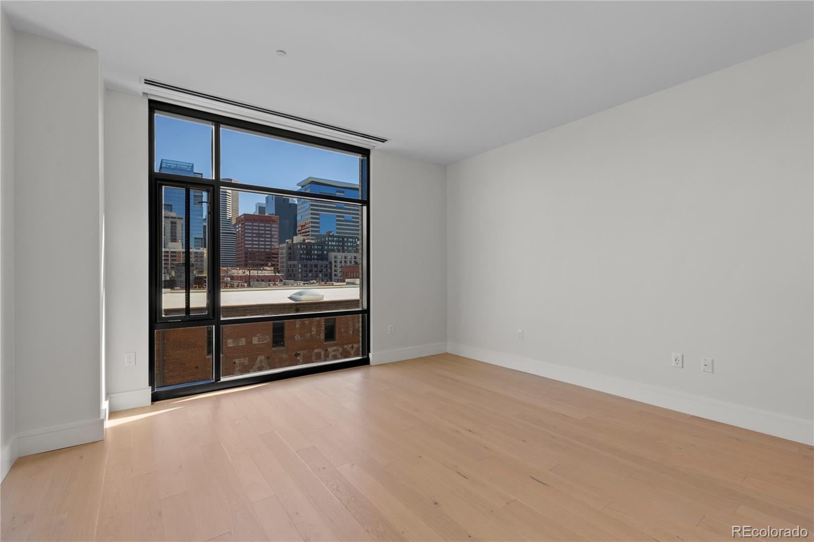 1901 Wazee Street, Unit 507 Denver, CO 80202 - Photo 17 of 45 a living room with stainless steel appliances a large window and front door