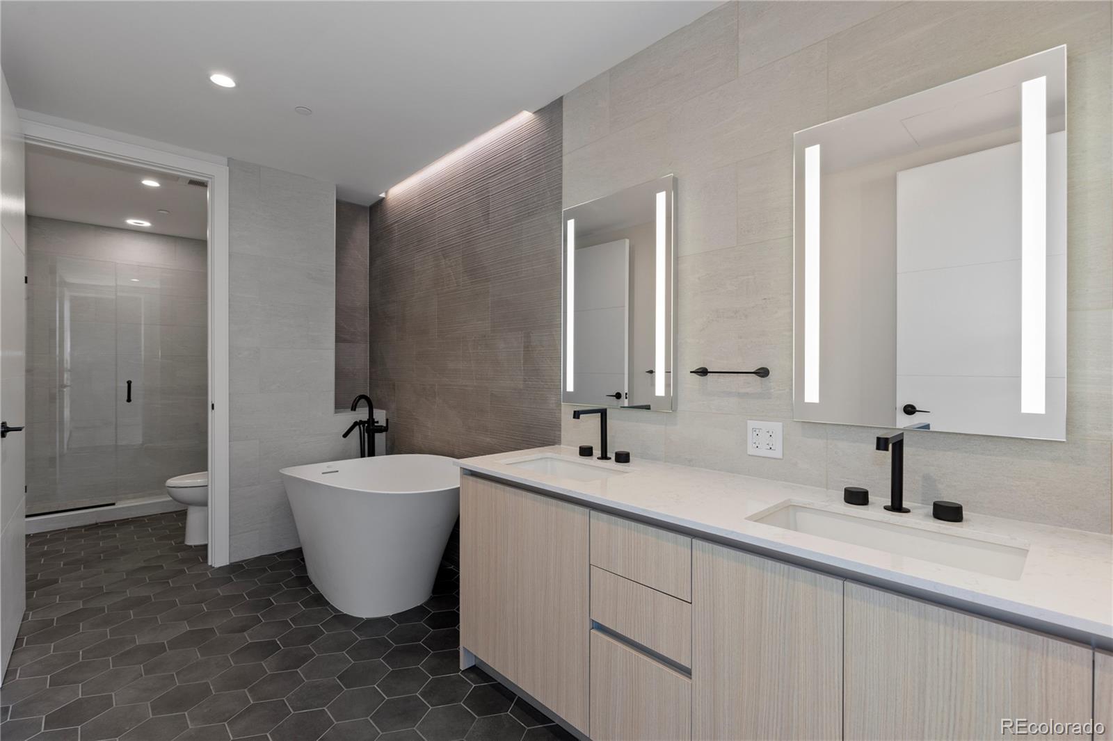 1901 Wazee Street, Unit 507 Denver, CO 80202 - Photo 2 of 45 a bathroom with a double vanity sink a mirror and a bathtub