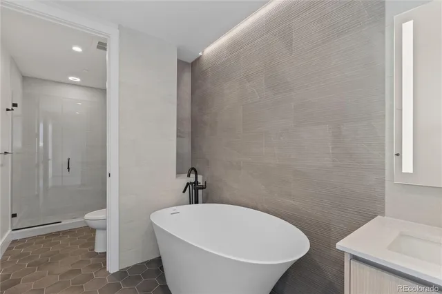 a white bath tub sitting next to a white toilet