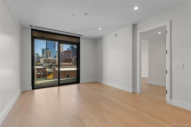 a view of an empty room with glass door
