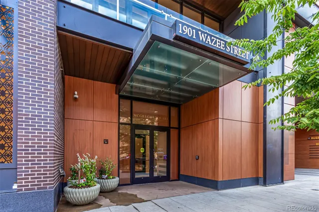 a gym room with lots of furniture and a chandelier