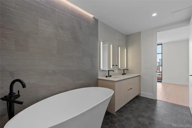 a bathroom with a double vanity sink and a bathtub