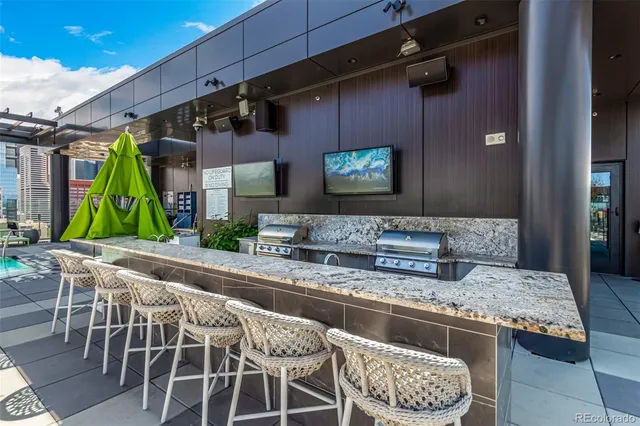 a view of a patio with couches potted plants and a table