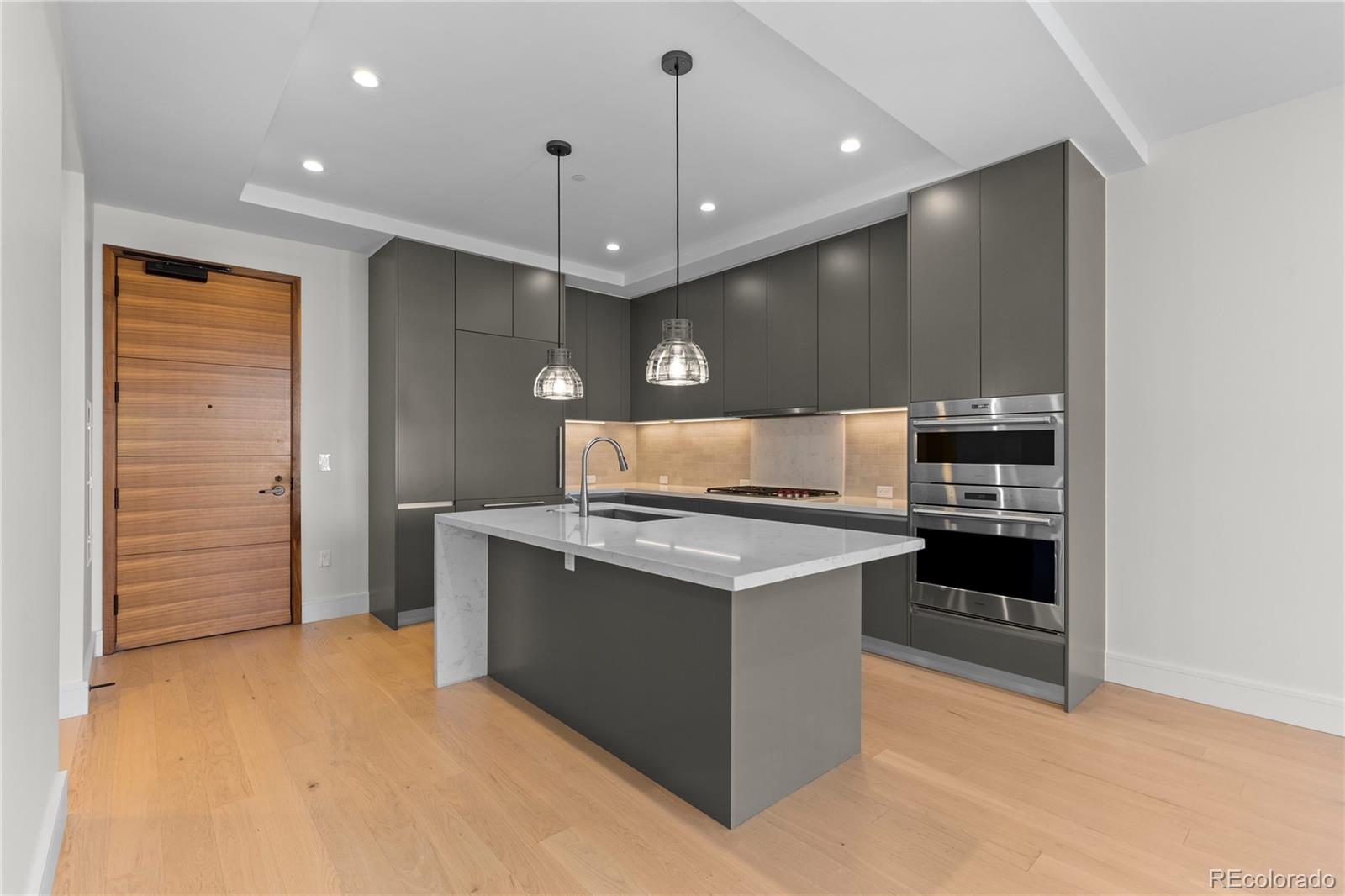 1901 Wazee Street, Unit 507 Denver, CO 80202 - Photo 7 of 45 a kitchen with stainless steel appliances a stove and cabinets