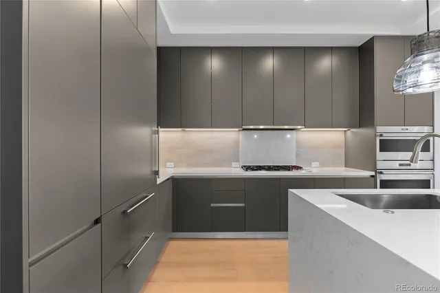a kitchen with kitchen island a sink stainless steel appliances and cabinets