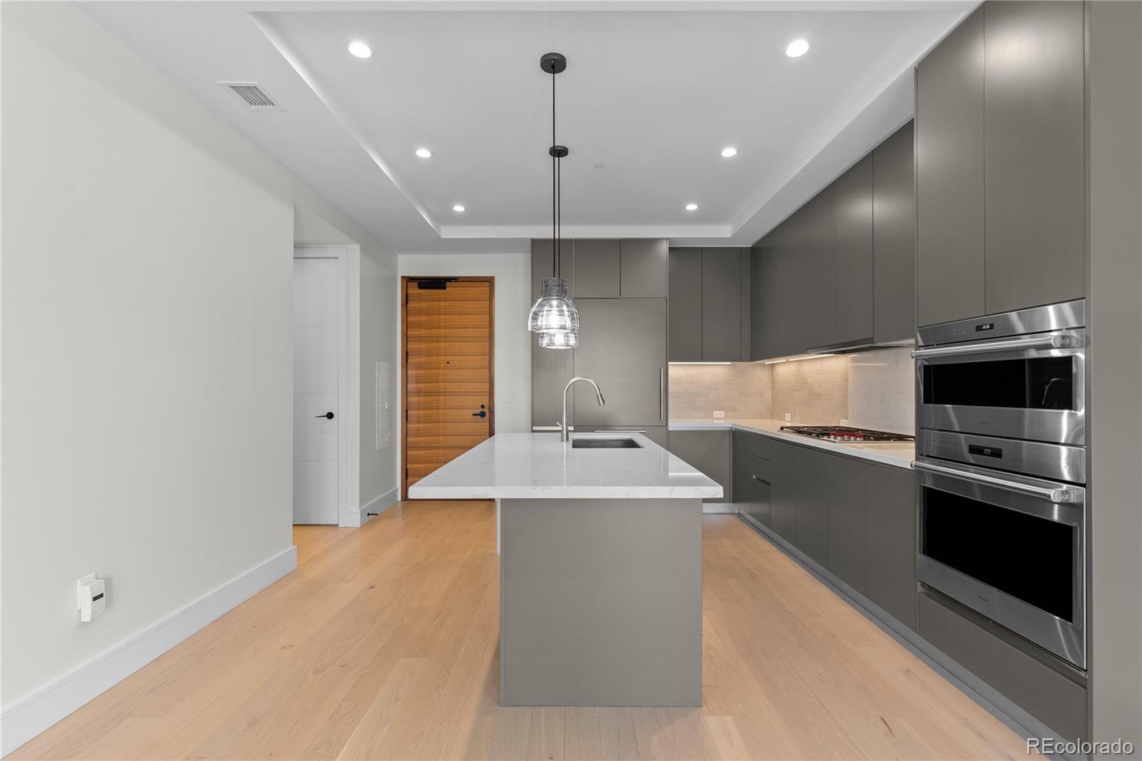 1901 Wazee Street, Unit 507 Denver, CO 80202 - Photo 9 of 45 a large kitchen with a sink and stainless steel appliances