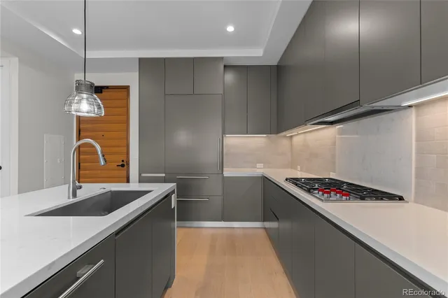 a kitchen that has a sink and a stove