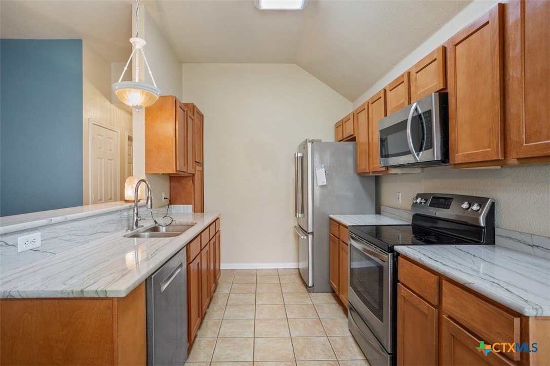 8 Sycamore Court Belton, TX 76513 - Photo 12 of 30 a kitchen with stainless steel appliances granite countertop a sink stove and refrigerator