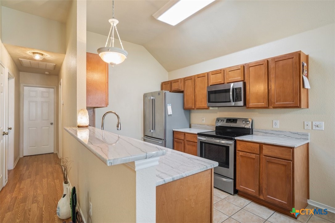 8 Sycamore Court Belton, TX 76513 - Photo 14 of 30 a kitchen with stainless steel appliances a sink stove and refrigerator