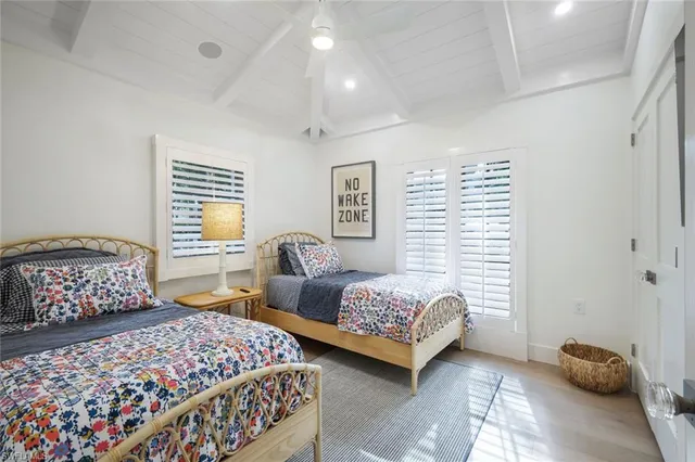 a bedroom with two beds and painting on the wall