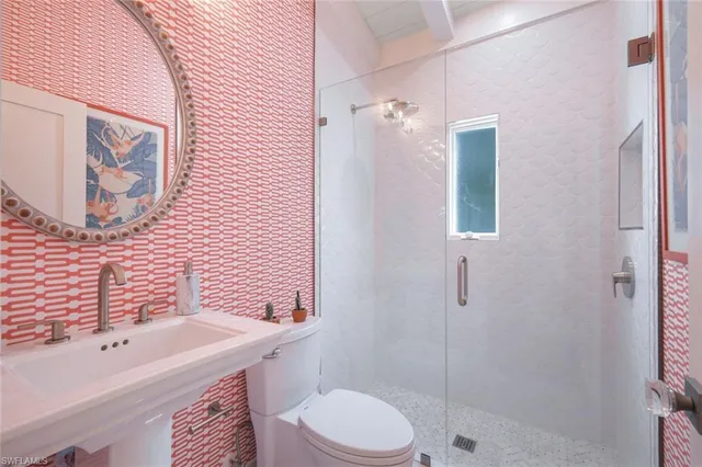a bathroom with a sink toilet and shower