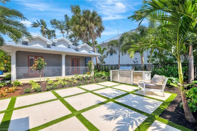 a view of backyard of house with outdoor seating