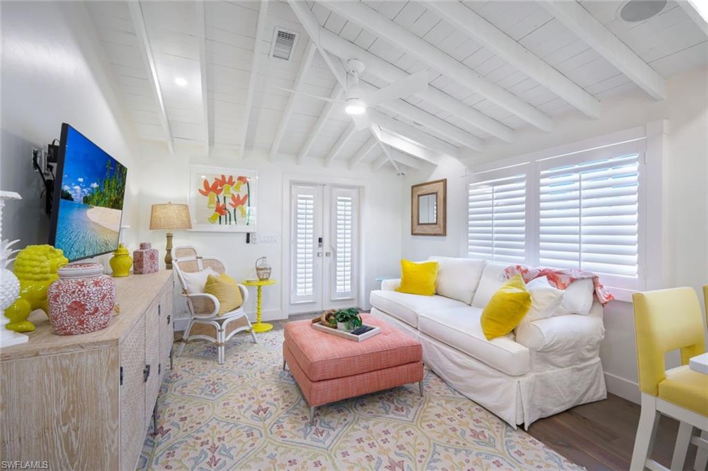 67 8th Avenue South Naples, FL 34102 - Photo 24 of 38 a living room with furniture and a window