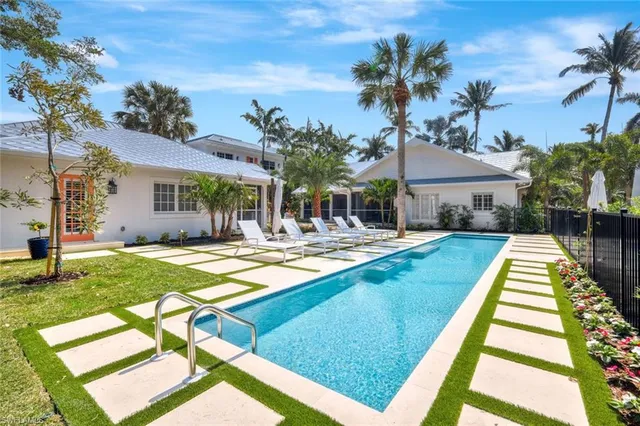 a view of swimming pool with a lounge chairs