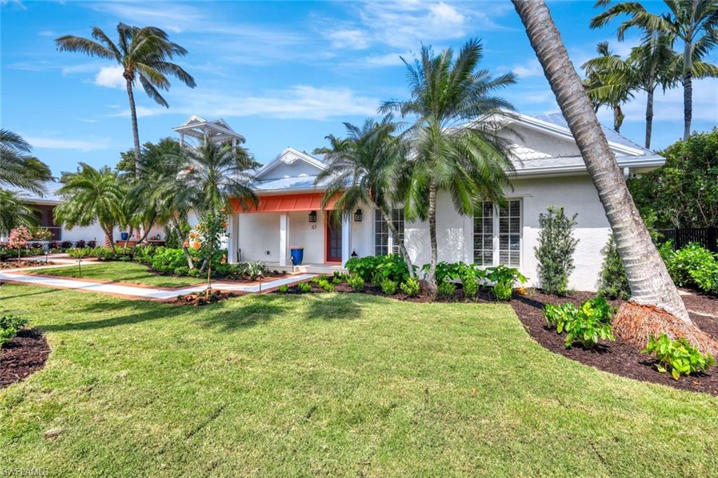 67 8th Avenue South Naples, FL 34102 - Photo 33 of 38 a front view of multi story residential apartment building with yard and green space