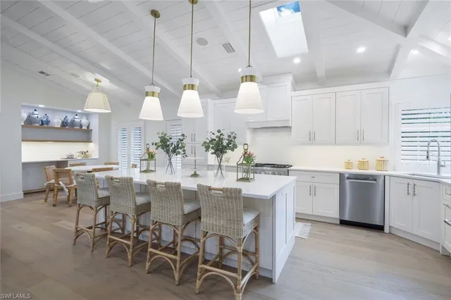a kitchen with center island table and chairs in it