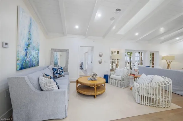 a bedroom with furniture and a large window