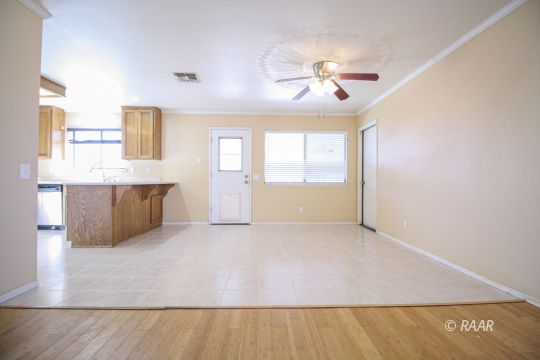 408 South Valley Street Ridgecrest, CA 93555 - Photo 6 of 29 a view of a livingroom with a ceiling fan window and wooden floor