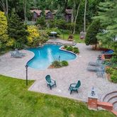 an aerial view of a house with a yard and lake view