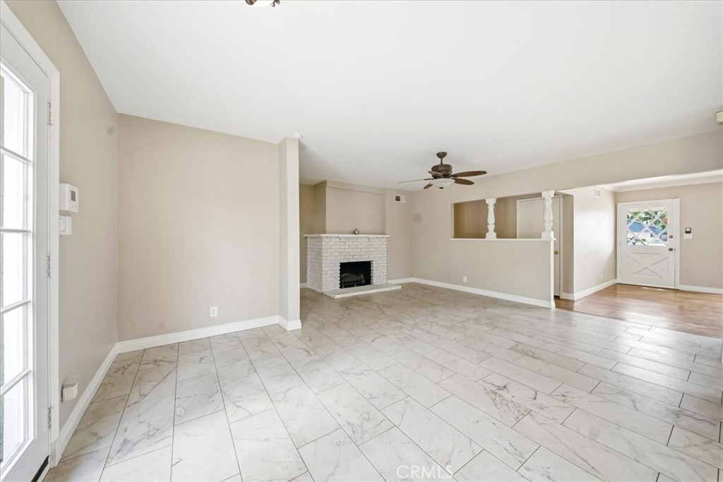 6481 Dos Rios Road Downey, CA 90240 - Photo 22 of 27 an empty room with windows and fireplace