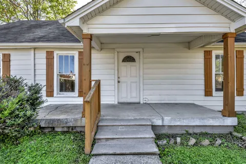 a front view of a house with a garden