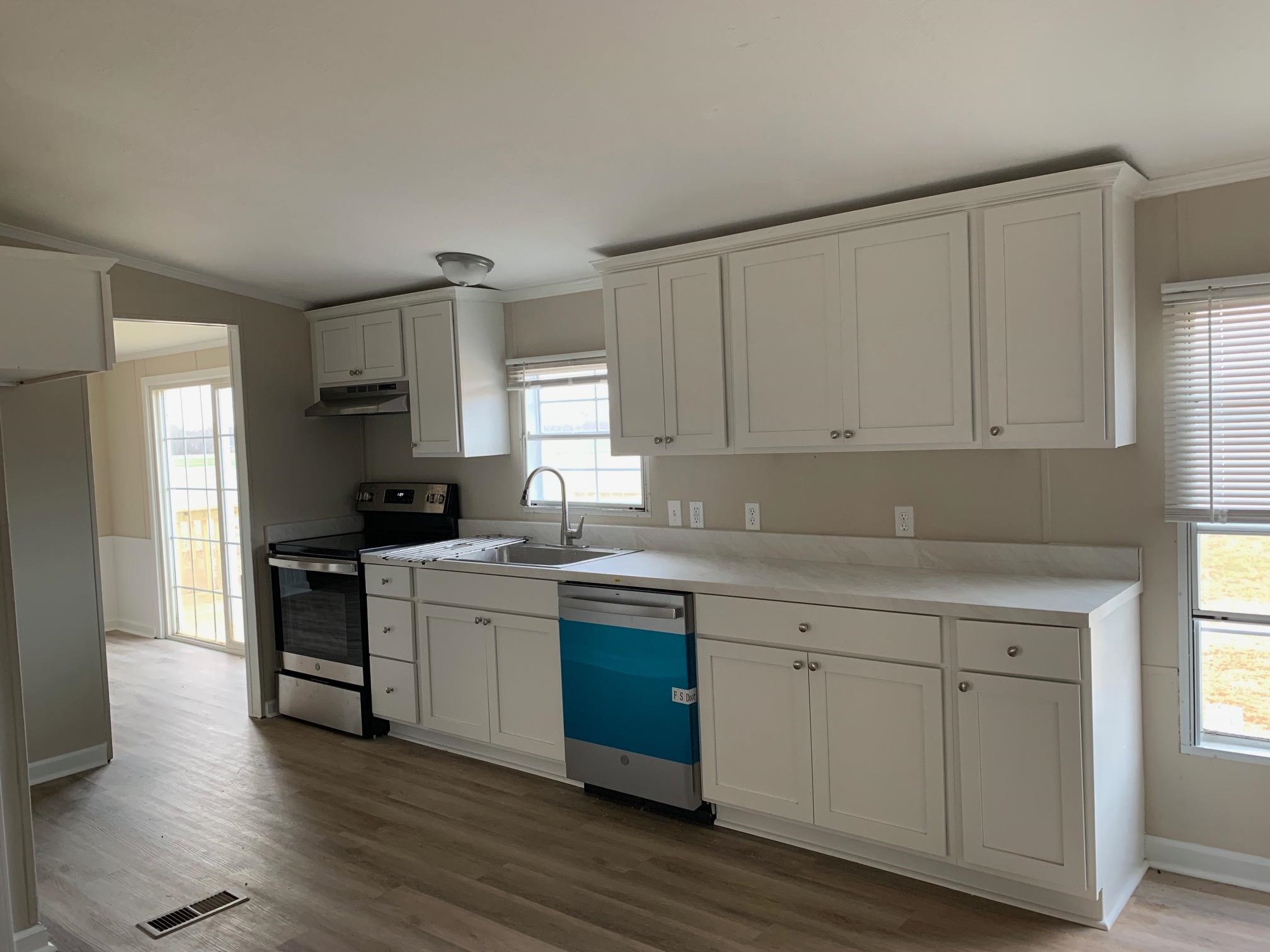 1827 Burks Road Henning, TN 38041 - Photo 10 of 17 a kitchen with white cabinets sink and stove
