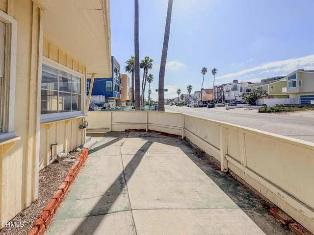 a view of a kitchen with a large window and potted plants