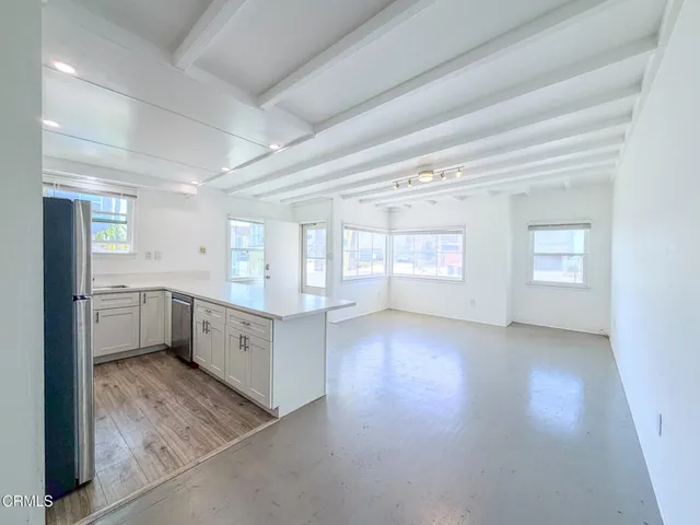 a view of a big room with chandelier and windows