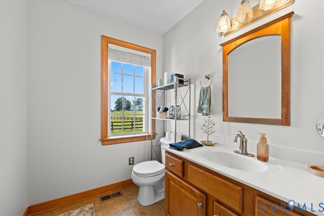 3137 Trenholm Road Powhatan, VA 23139 - Photo 26 of 72 a bathroom with a granite countertop toilet sink and mirror