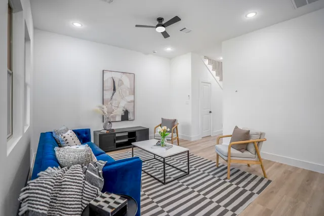 a living room with furniture and wooden floor