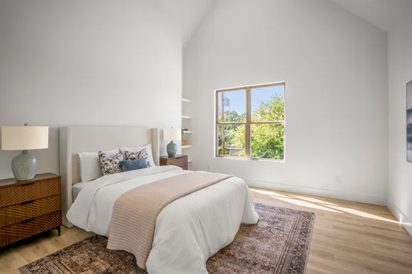 a bedroom with a bed and a window