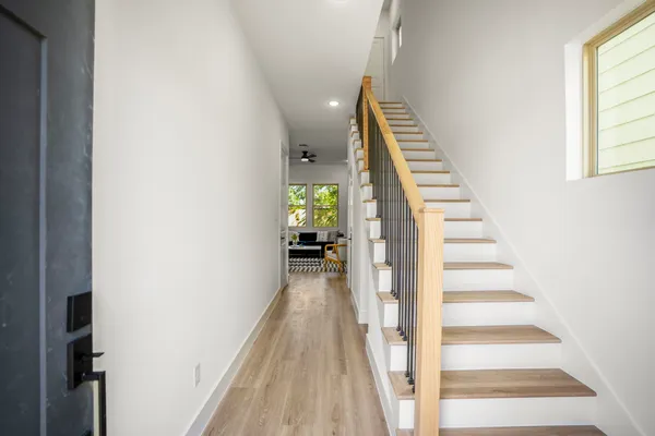 a view of entryway and hall with wooden floor