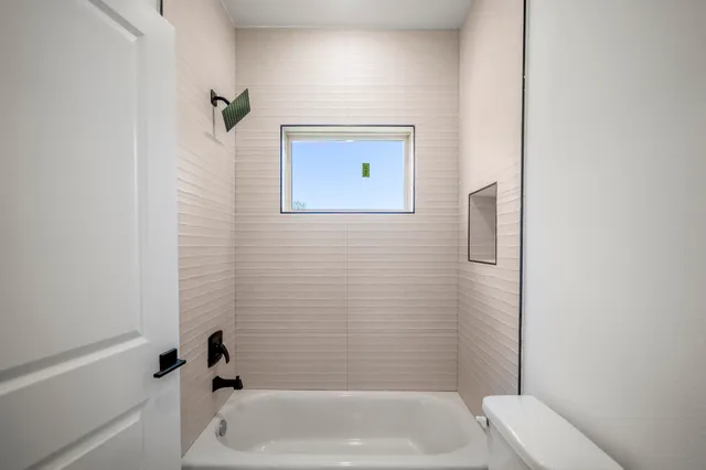 a bathroom with a bathtub and a shower