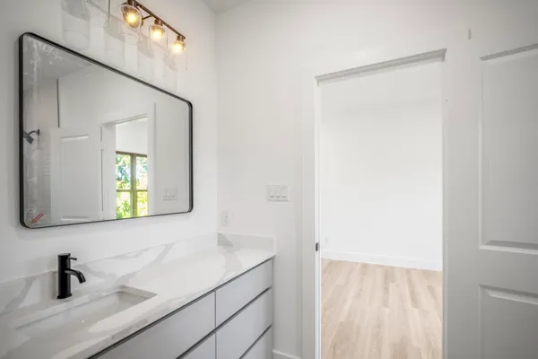 a bathroom with a sink a mirror and window
