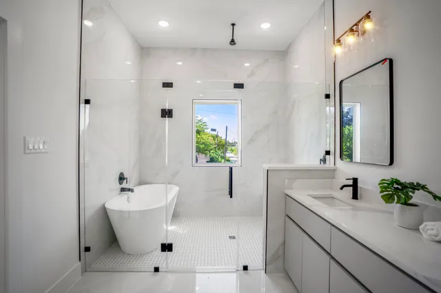 a bathroom with a white sink a mirror and a bathtub