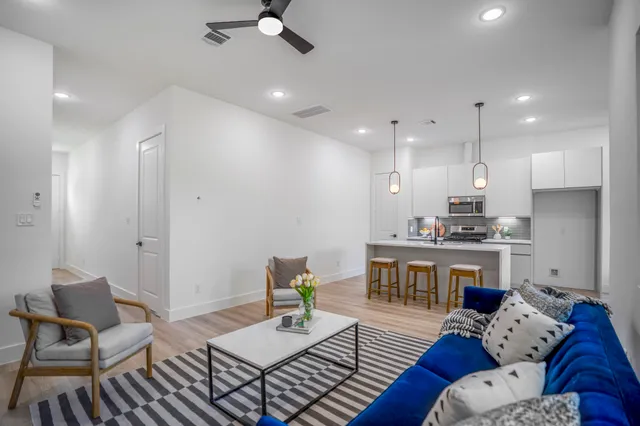a living room with furniture and kitchen view